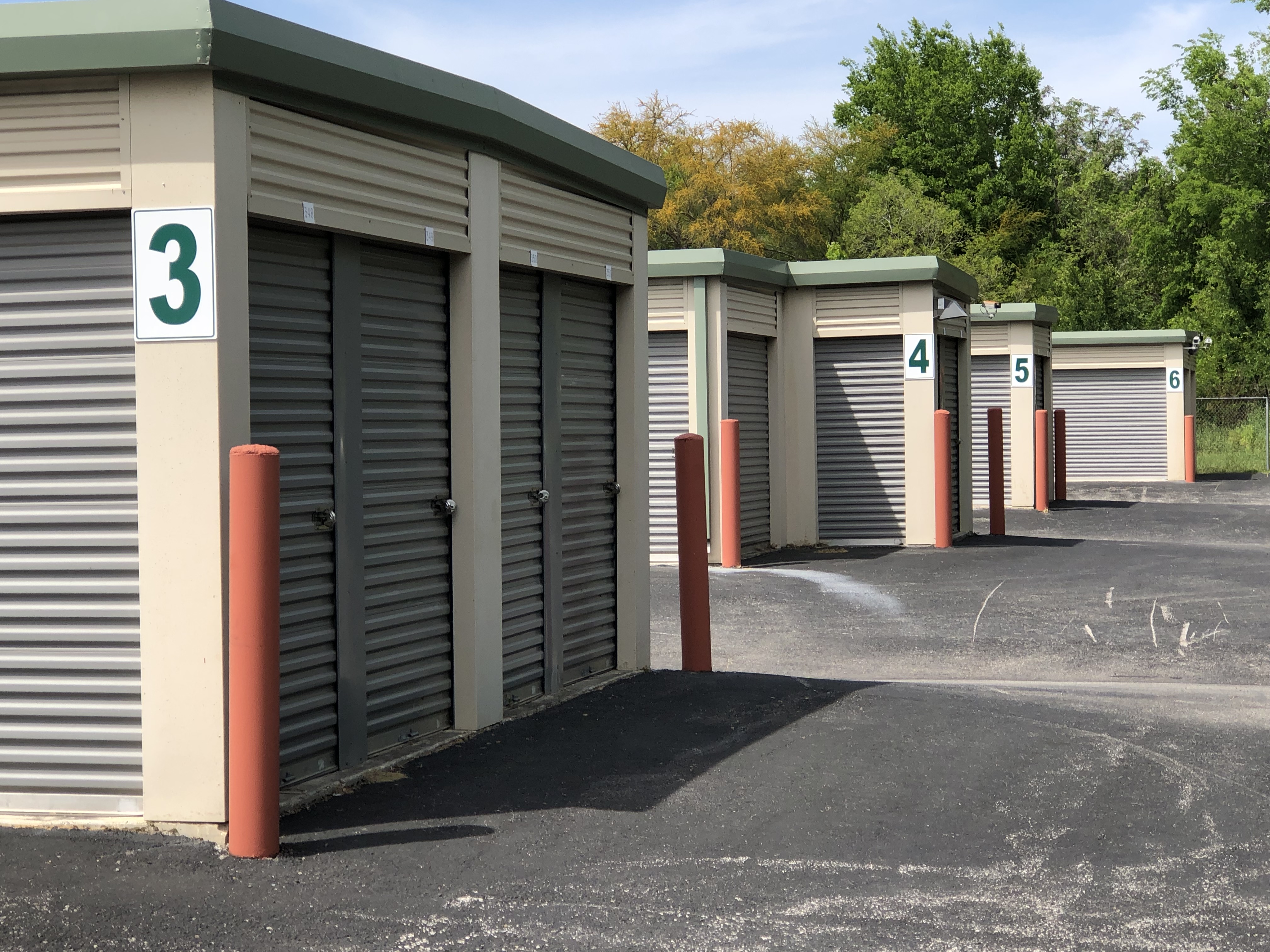 This image shows that the doors to our storage units are metal rollup doors that latch to the side and are held shut by a disc lock which is circular in shape in far more secure than padlocks