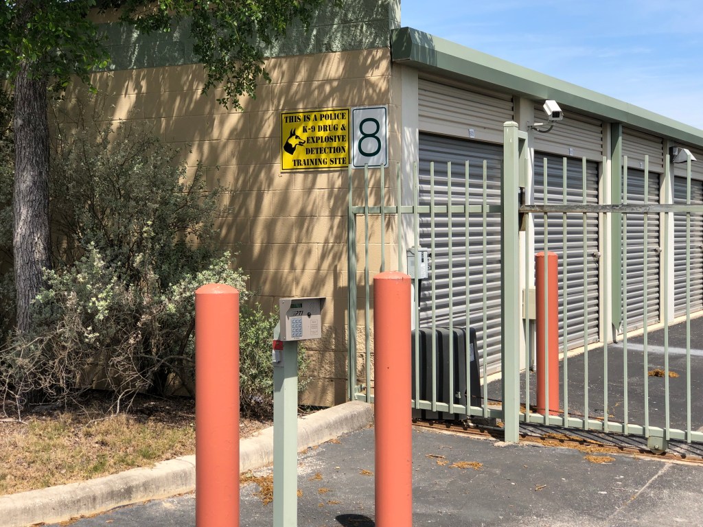 Picture of our gate access controlled keypad located to the left of the our office building